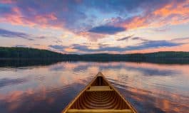Bow of a cedar canoe on a lake at sunset - Ontario, Canada