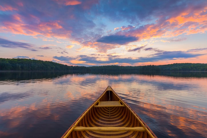 Bow of a cedar canoe on a lake at sunset - Ontario, Canada