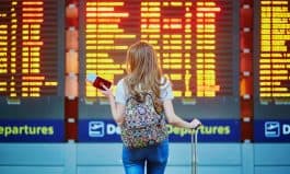 Tourist girl with backpack in international airport