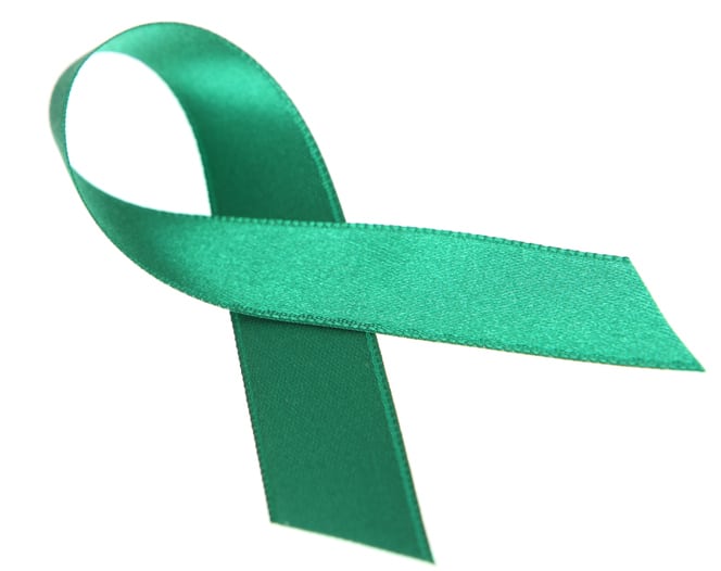 Green silk awareness ribbon on white background