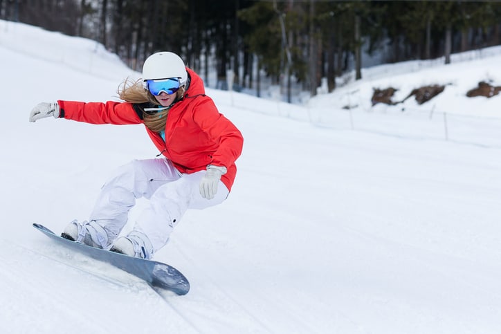 Ssnowboarder on slopes in the sunny morning