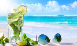 tropic summer vacation; Exotic drinks on blur tropical beach background